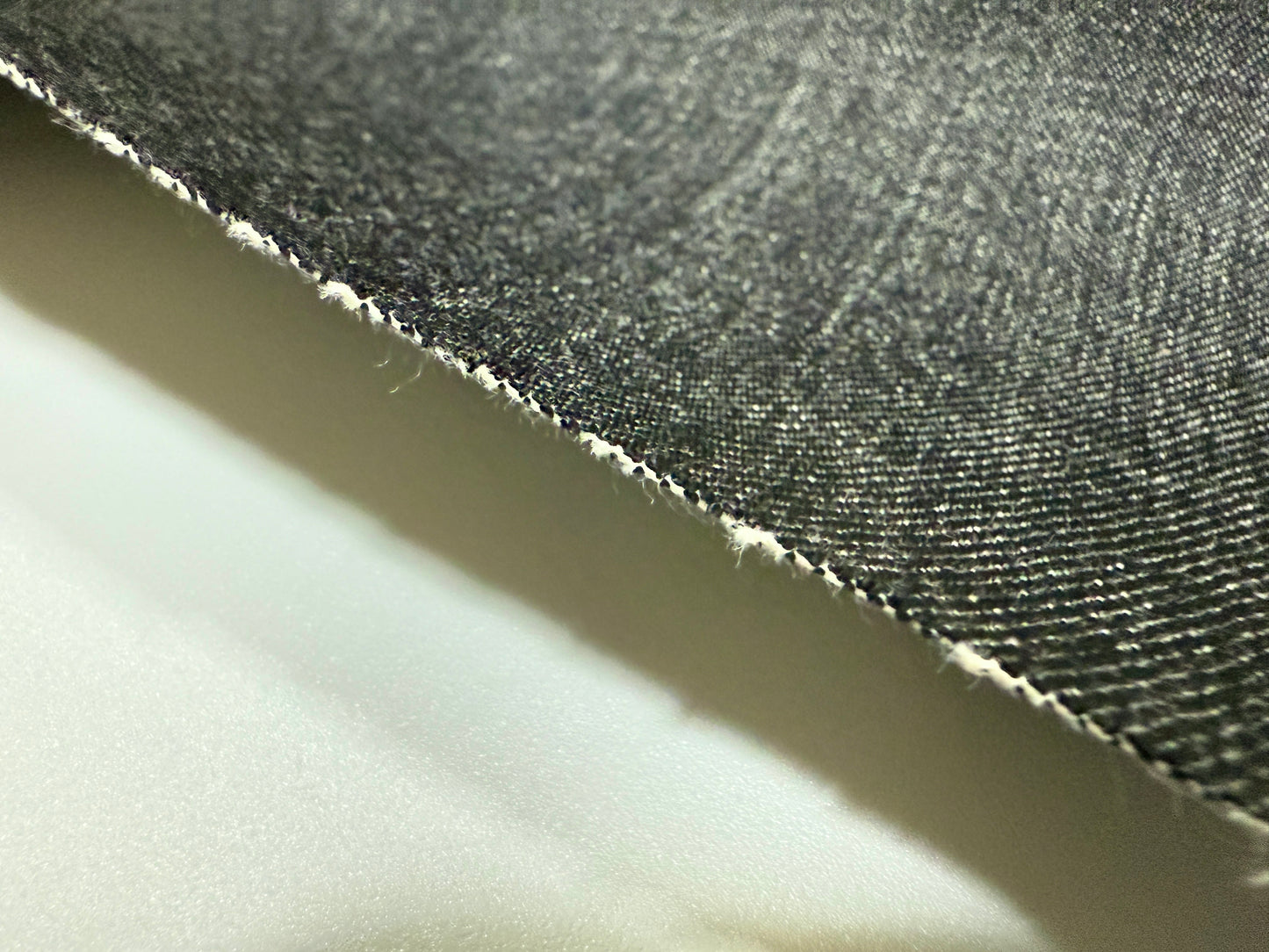 Close-up of Okayama Denim showing the texture and selvage edge of the 16.5 oz Japanese Heavy Ounce Indigo denim.