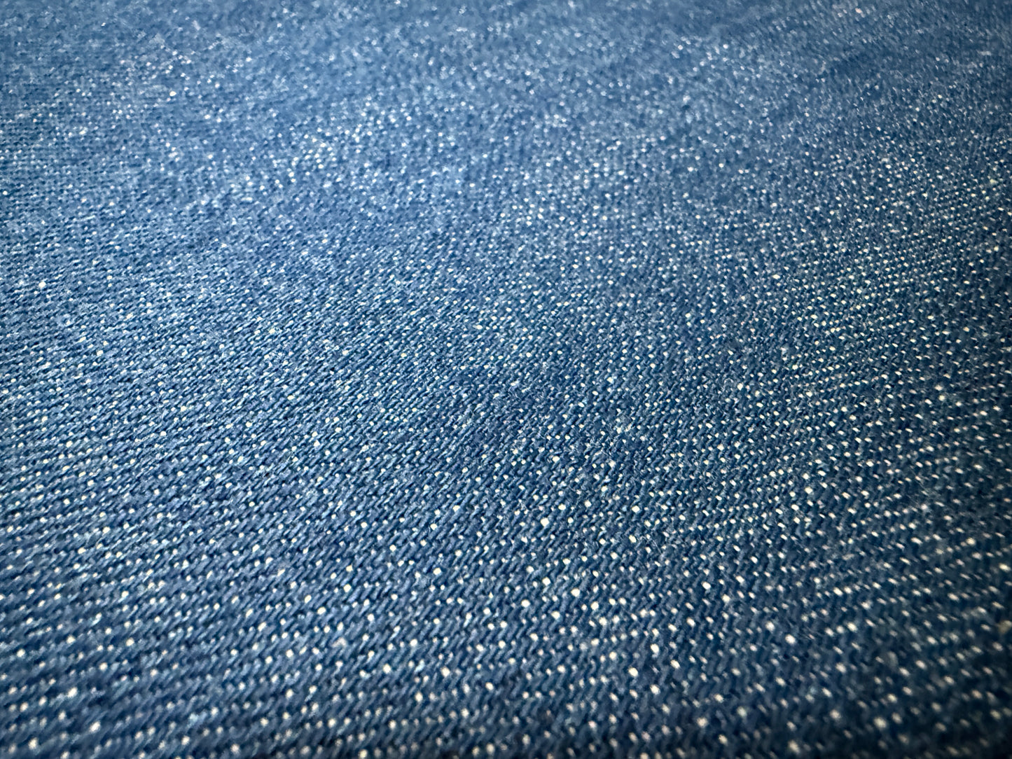 Okayama Denim | 12.5 oz Japanese Indigo Slub Denim fabric texture close-up, showcasing the unique slub yarn design.