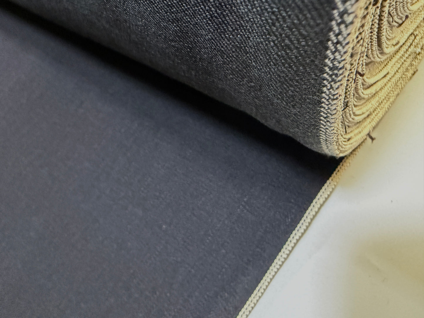 Okayama Denim | 12.5oz double-sided black Japanese selvage fabric roll showcasing smooth texture.