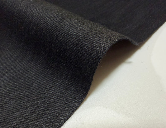 Okayama Denim 10 oz Cotton All Black kibata Selvage Denim fabric close-up, showcasing its rugged texture and deep black color.