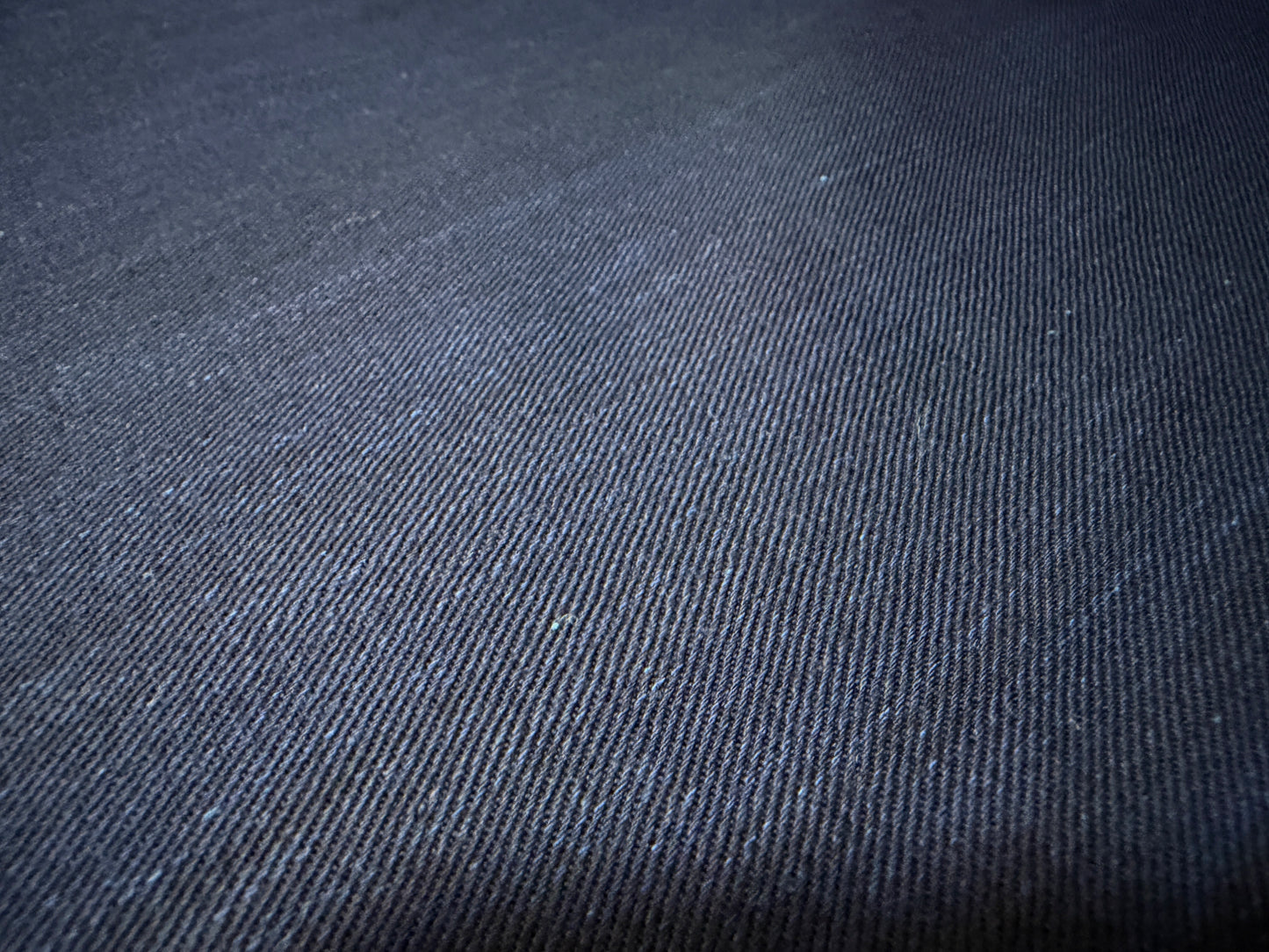Okayama Denim fabric texture showcasing dark indigo color and soft surface, perfect for shirt-making.