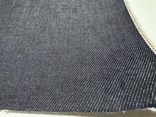 Okayama Denim | Premium 10.5 oz Japanese Indigo Selvage Denim fabric showcasing a smooth texture and rich dark blue color.