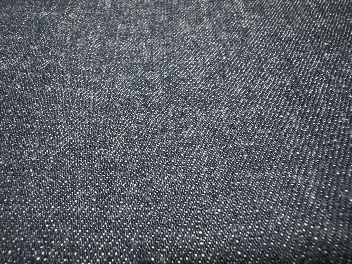 Okayama Denim | 12.5 oz Japanese Indigo Kibata Selvage Denim texture close-up showing intricate weave and quality.