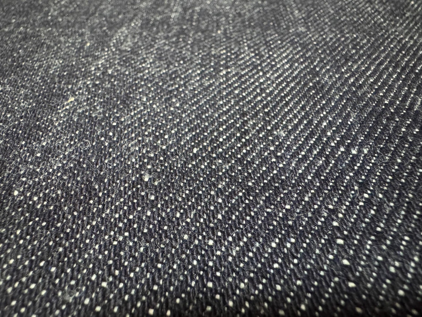 Close-up of Okayama Denim, showcasing the unique texture of 19.5 oz Japanese Heavy Ounce Indigo Selvage denim.
