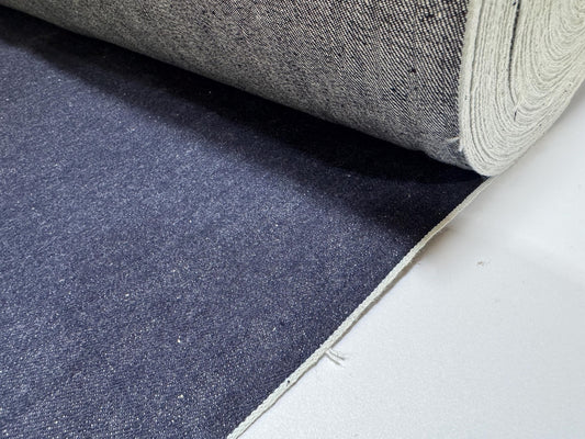 Okayama Denim | 11.5oz indigo rigid selvage Japanese denim fabric roll showcasing its smooth texture and dark blue color.