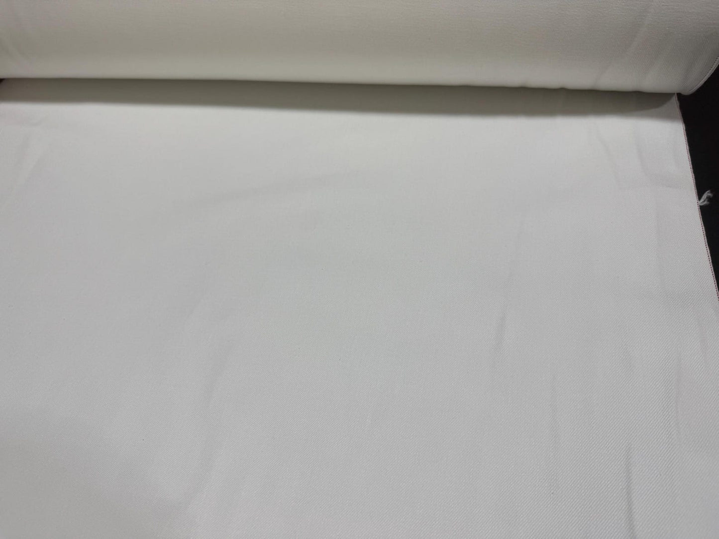 Okayama Denim 13 oz White Selvage fabric roll showcasing its smooth texture and high quality.