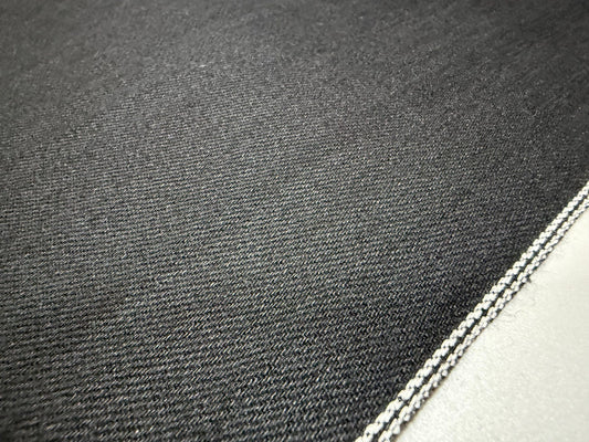 Okayama Denim | 11oz double-sided black Japanese black selvage fabric close-up showing smooth texture and selvedge