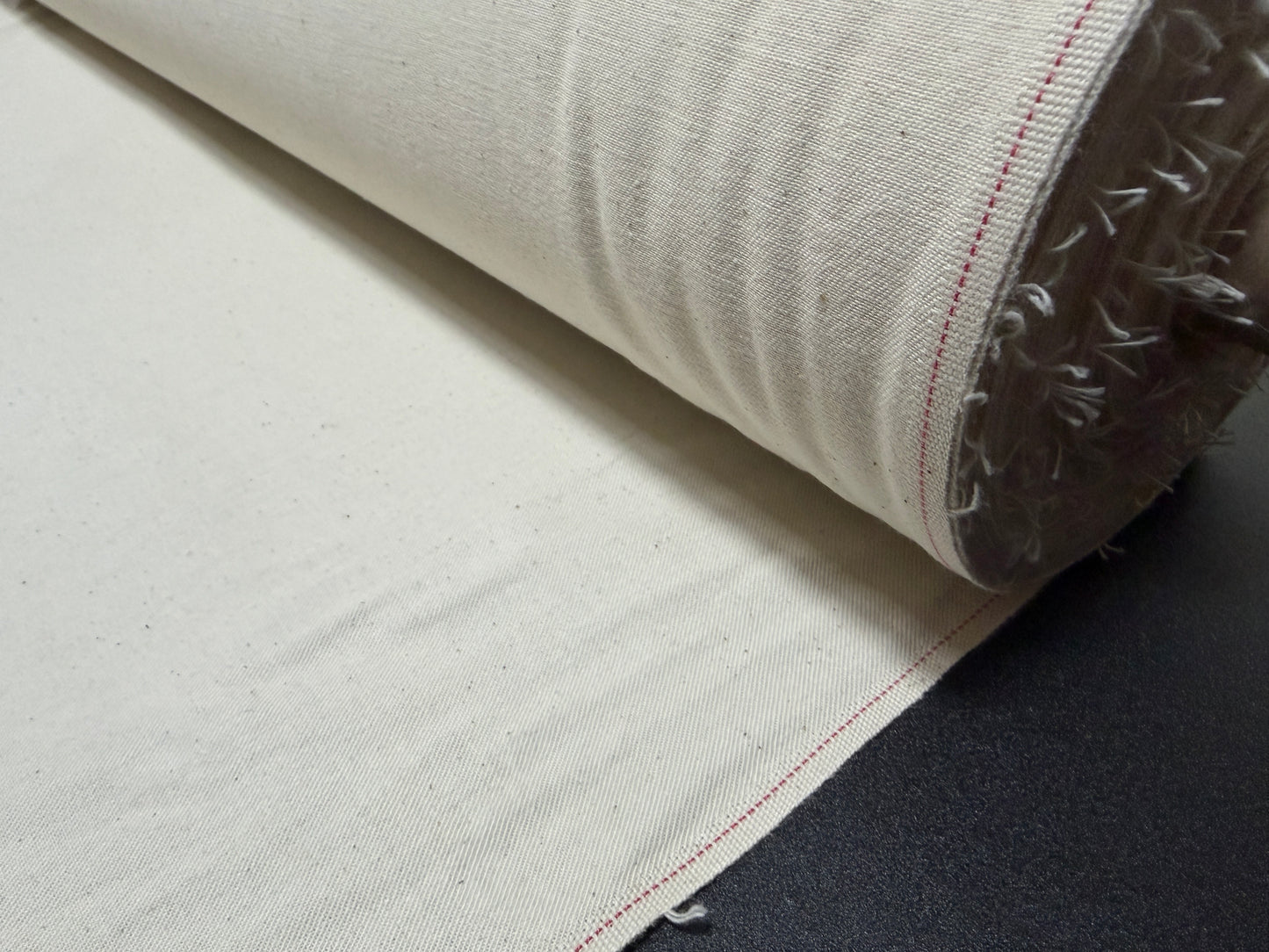 Okayama Denim cotton slake fabric roll showcasing natural color and texture for jean pockets.