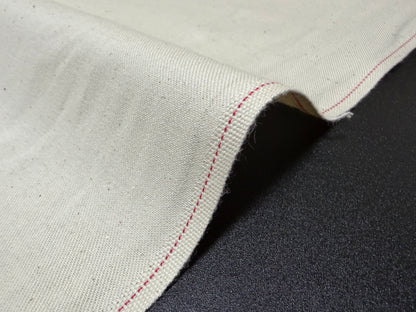 Okayama Denim Cotton Slake Fabric with red stitching detail, ideal for jeans pockets, showcasing natural cotton texture.