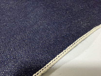 Okayama Denim 13 oz Japanese Indigo Kibata Selvage Denim fabric showing the raw edge and weave.