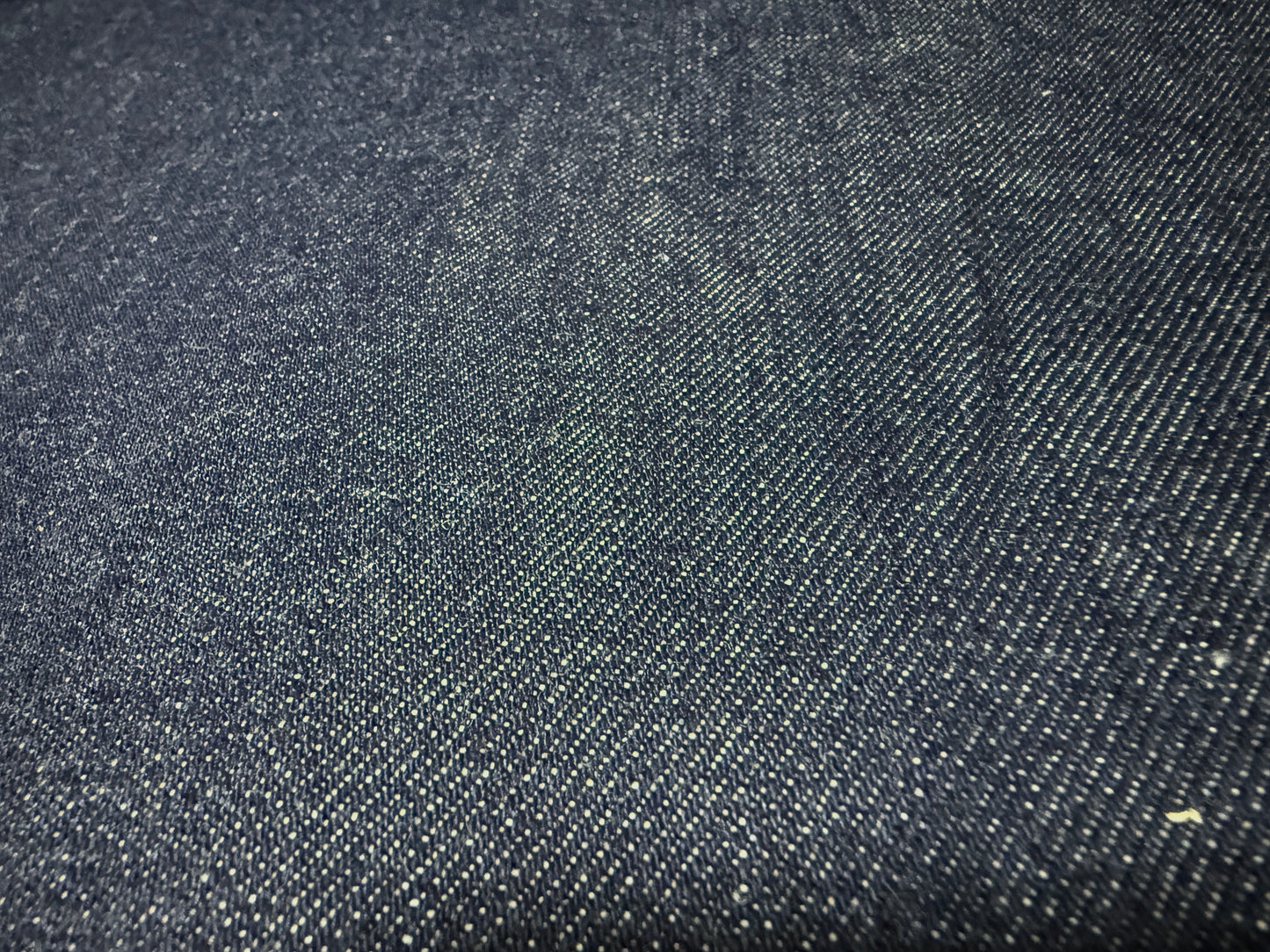 Okayama Denim | 13 oz Japanese Indigo Kibata Selvage Denim fabric close-up showing texture and color.