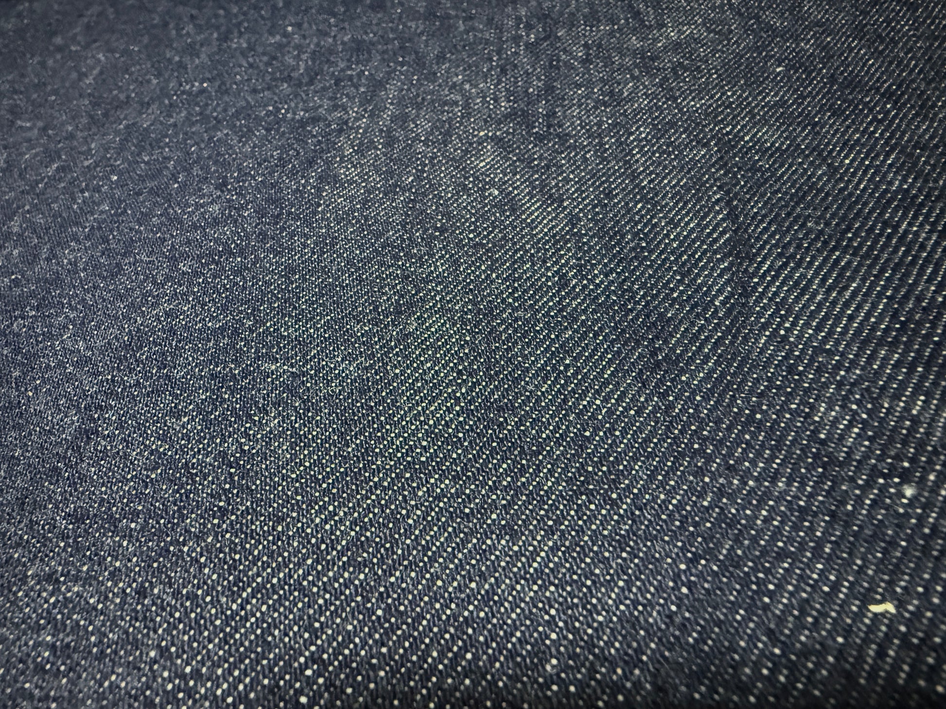 Okayama Denim | 13 oz Japanese Indigo Kibata Selvage Denim fabric close-up showing texture and color.