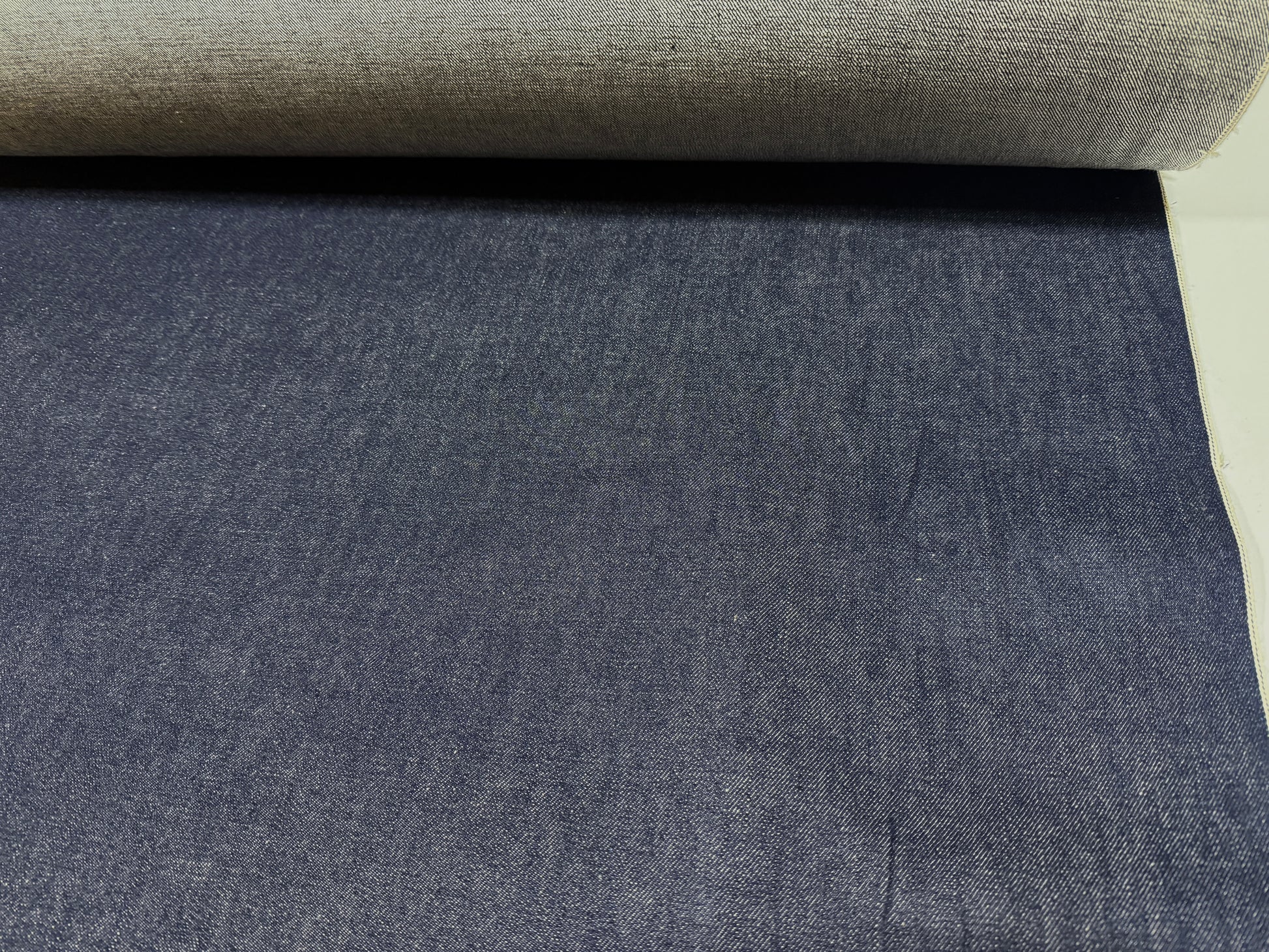 Okayama Denim 13 oz Japanese Indigo Kibata Selvage Denim fabric showing rich dark blue texture.
