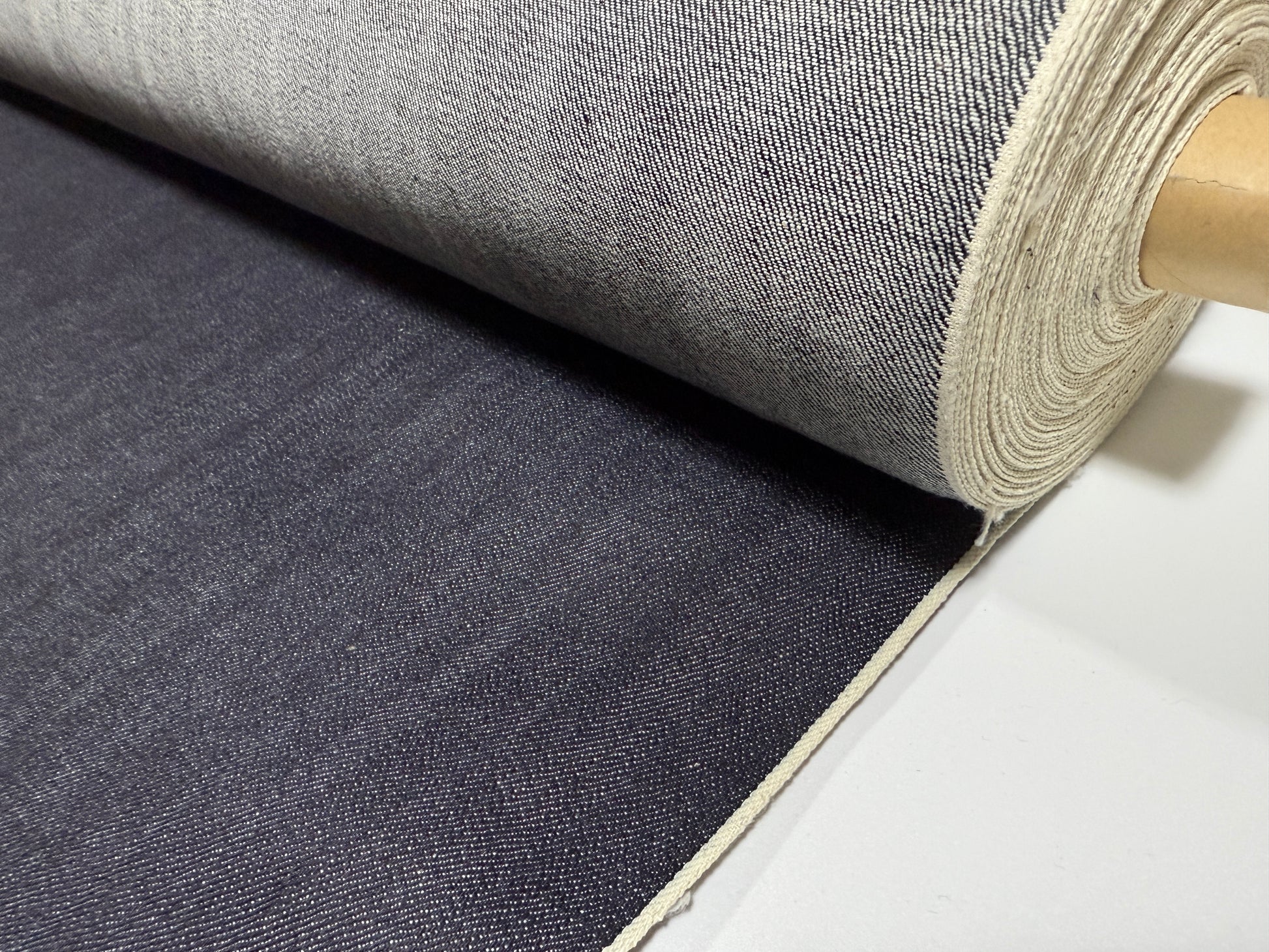 Okayama Denim roll showcasing 12.5 oz indigo Japanese selvage denim fabric by yard for versatile apparel projects.