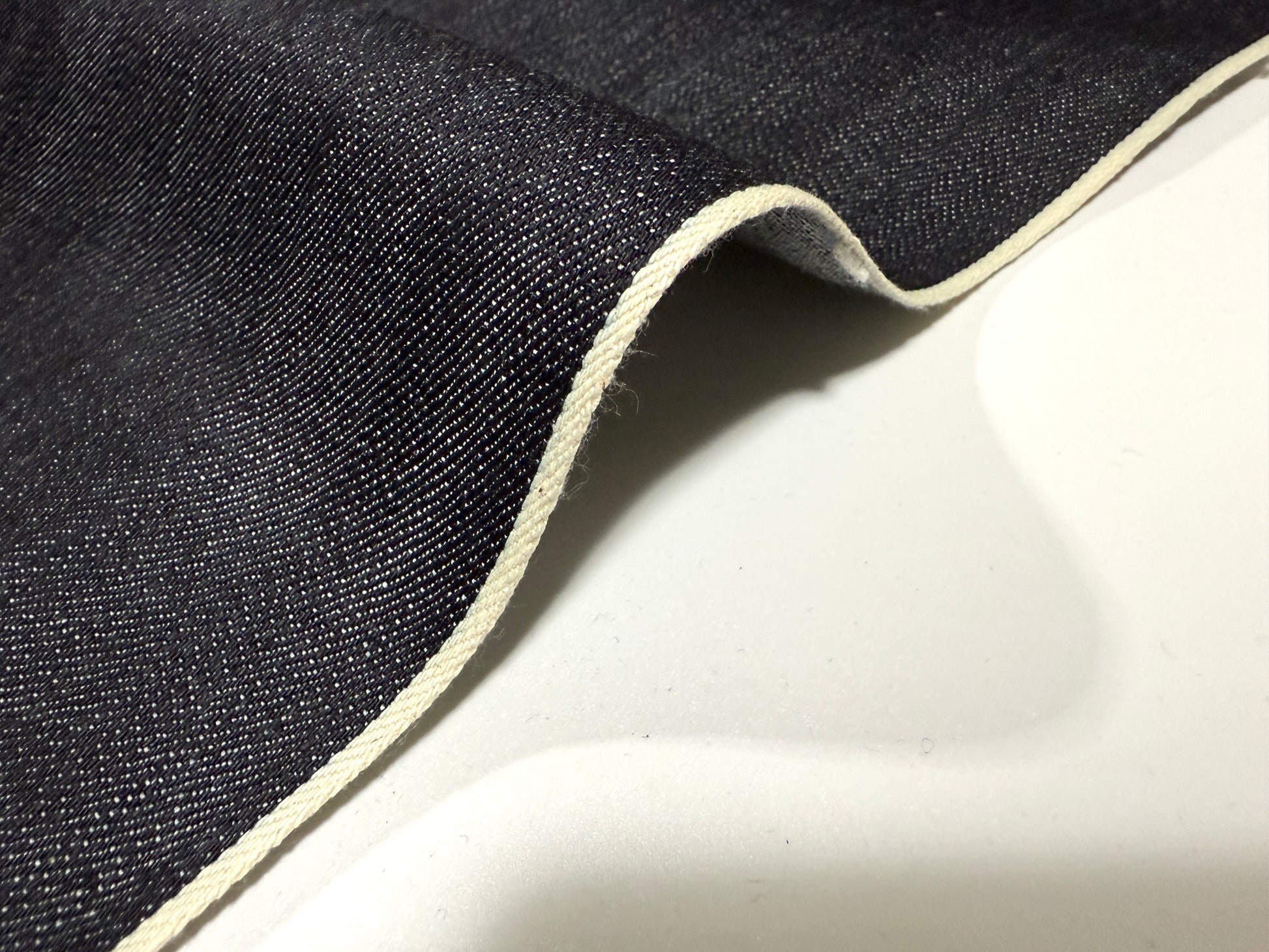 Okayama Denim 12.5 oz indigo Japanese selvage denim fabric showcasing white selvage edge.