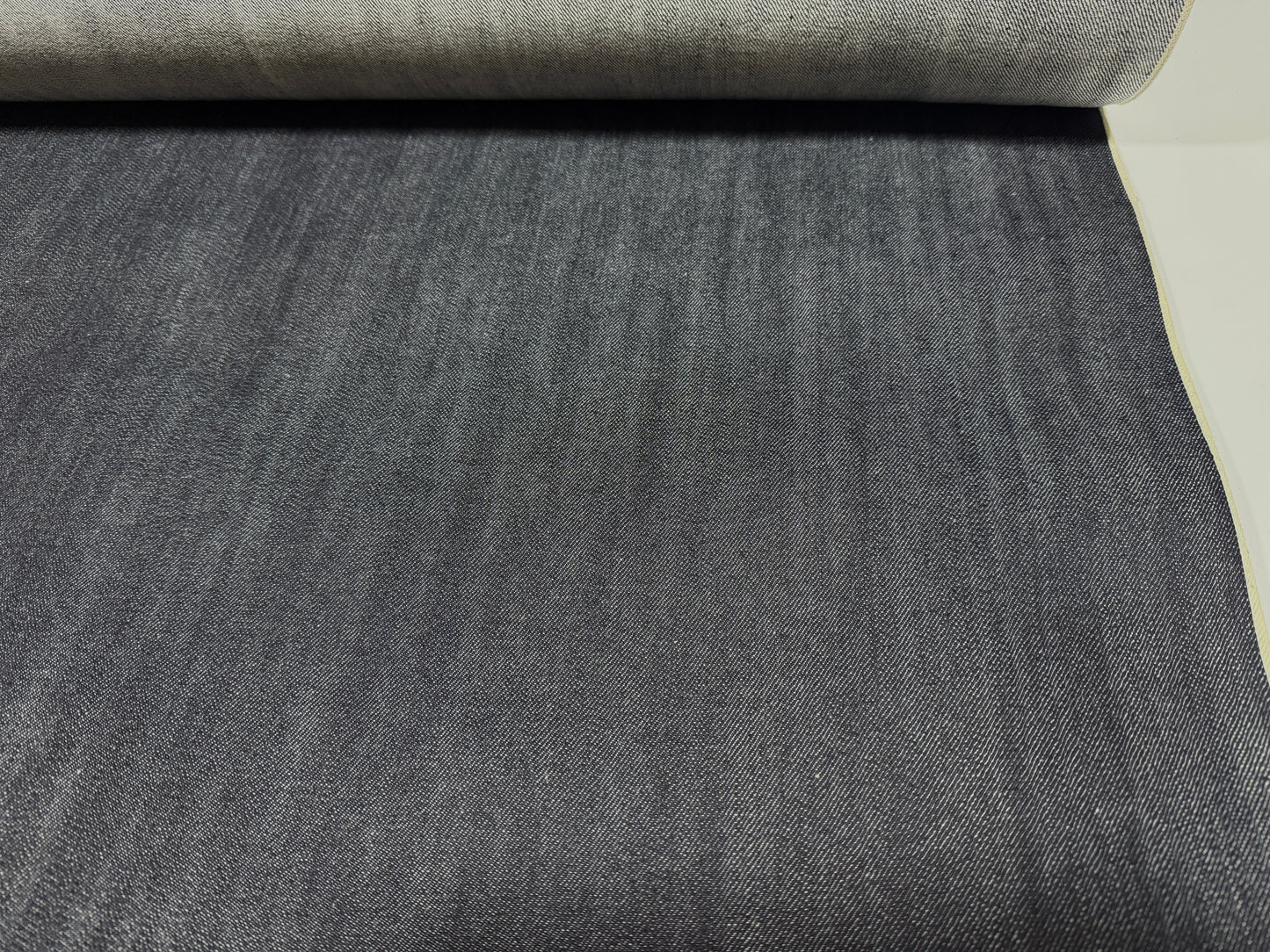 Okayama Denim | 12.5 oz Indigo Japanese selvage denim fabric roll showcasing dark blue texture