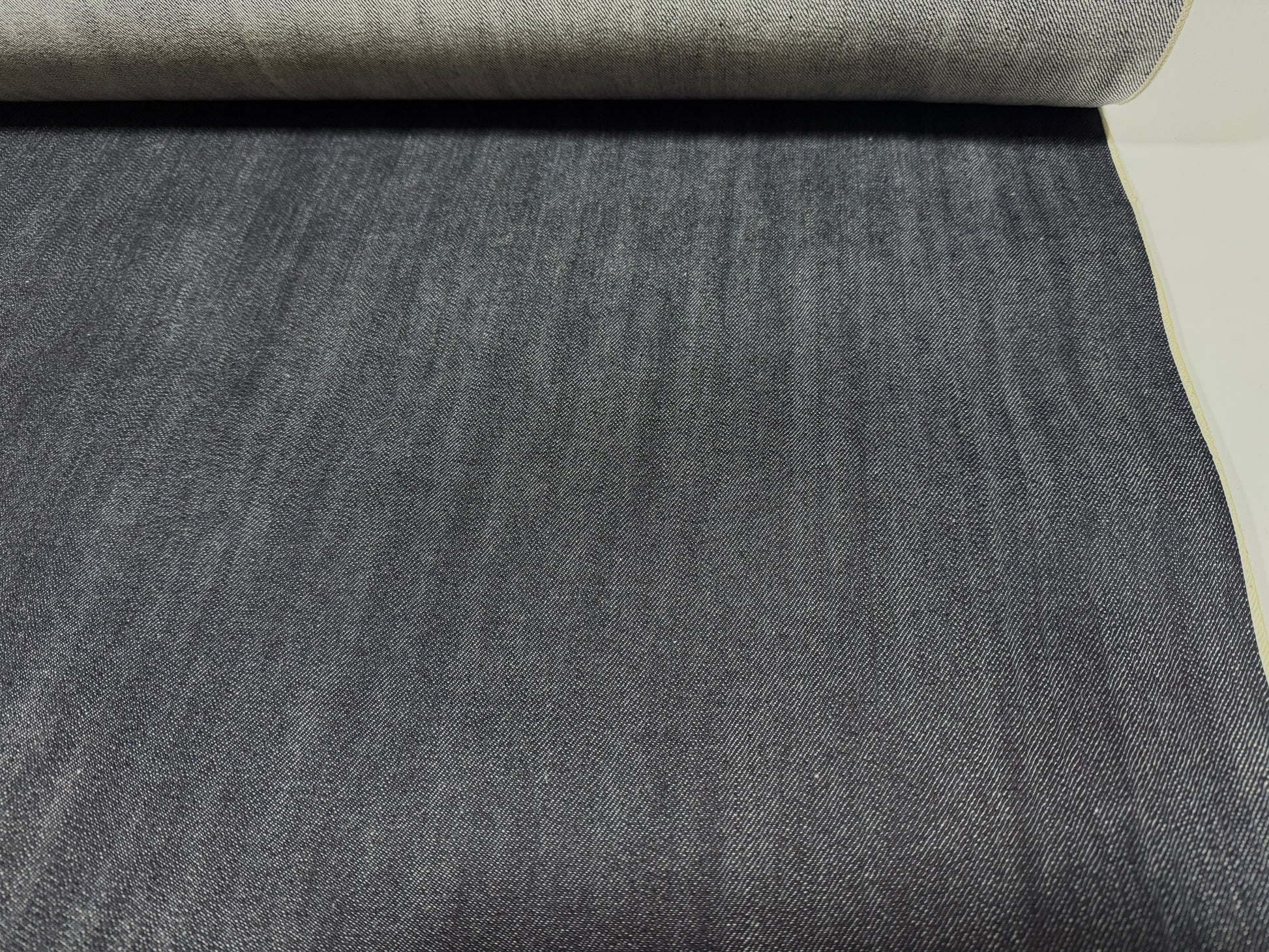 Okayama Denim | 12.5 oz Indigo Japanese selvage denim fabric roll showcasing dark blue texture