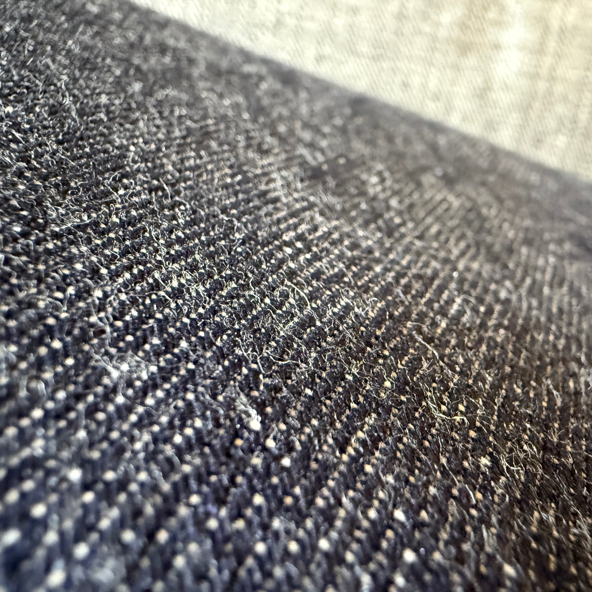 Close-up of Okayama Denim 13.5oz indigo kibata Japanese selvage fabric showing its raw texture.