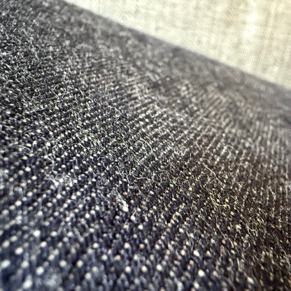 Close-up of Okayama Denim 13.5oz indigo kibata Japanese selvage fabric showing its raw texture.