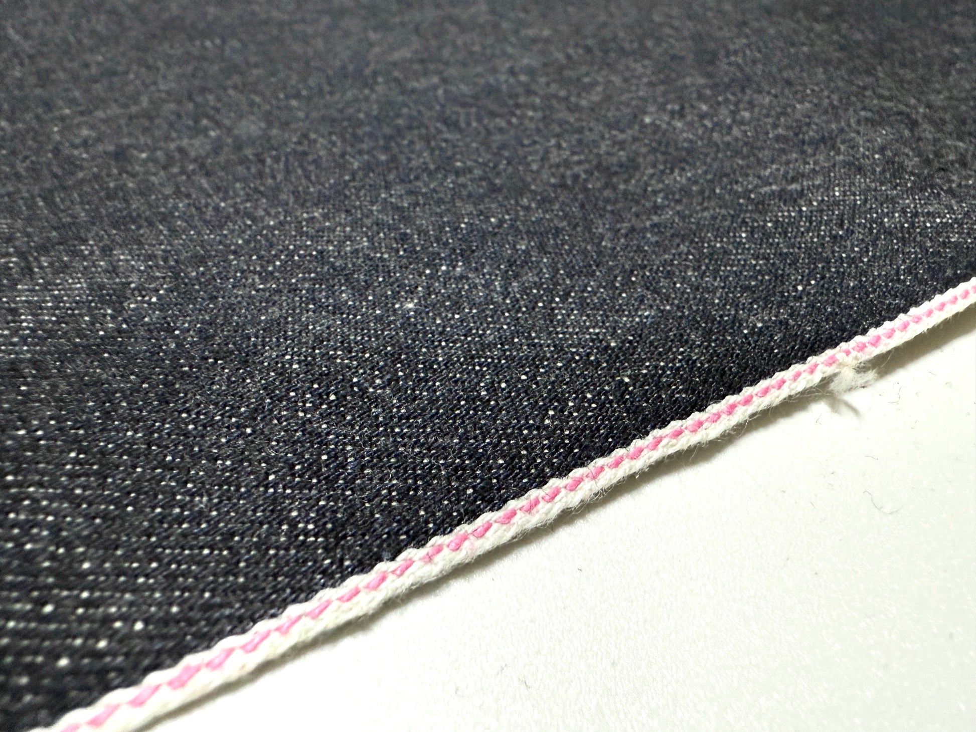 Okayama Denim 13.5oz indigo kibata Japanese selvage fabric yard with pink selvage detail.