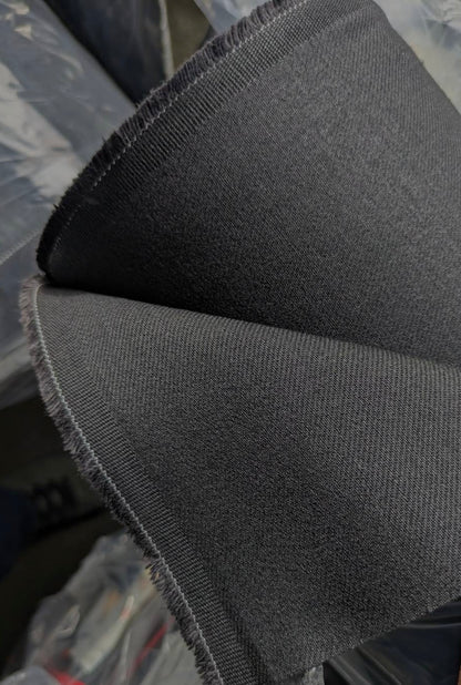 Close-up of Okayama Denim | 13.3oz double-width, double-sided black denim fabric showcasing its beautiful twill texture.