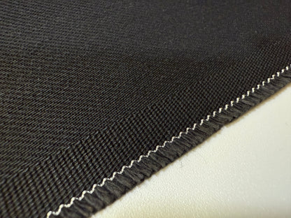 Okayama Denim | Close-up of 13.3oz double-width, double-sided black denim fabric with twill texture.