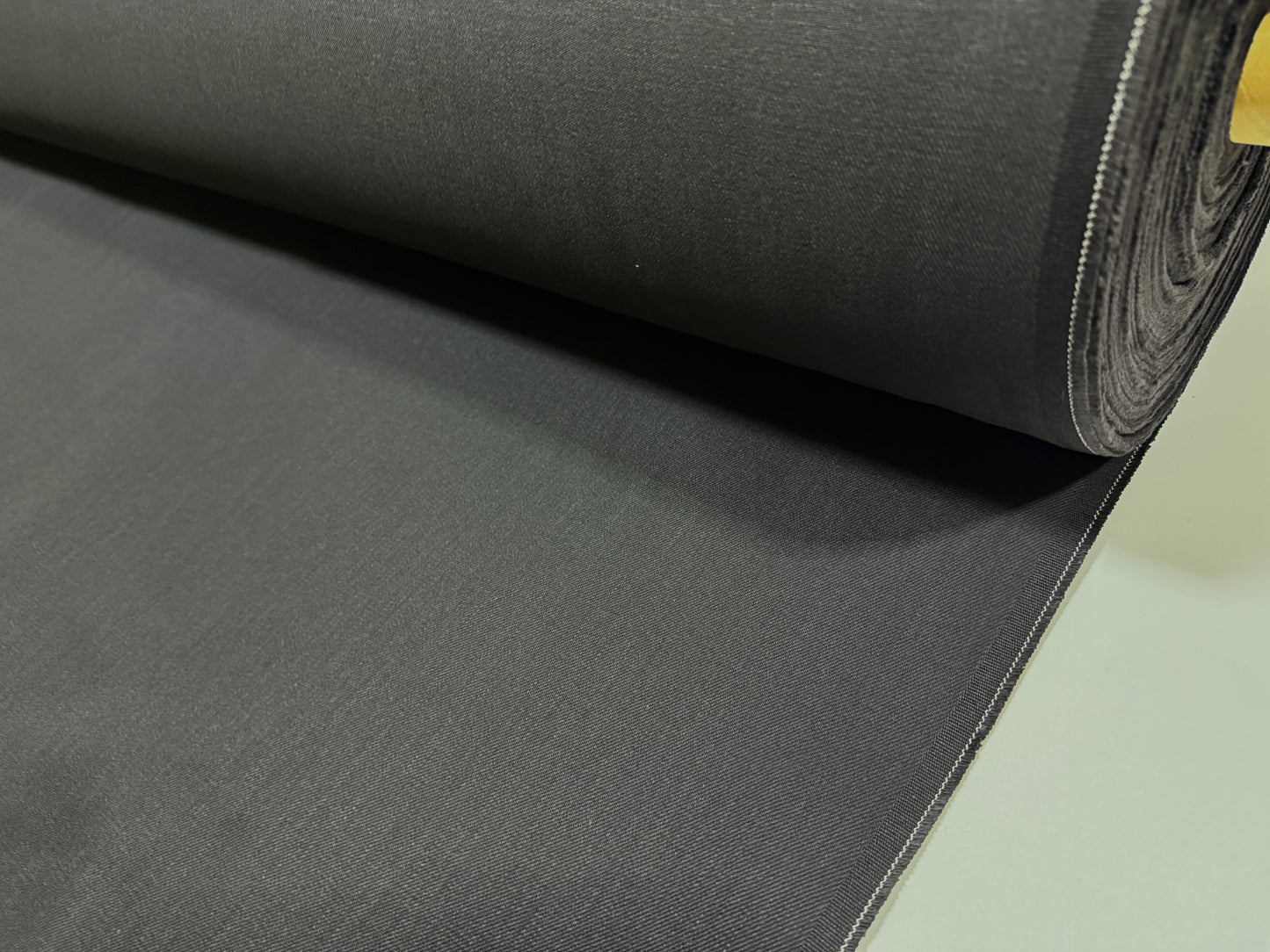 Okayama Denim | 13.3oz Double Width Double-Sided Black denim fabric roll showcasing its smooth texture and dark color.