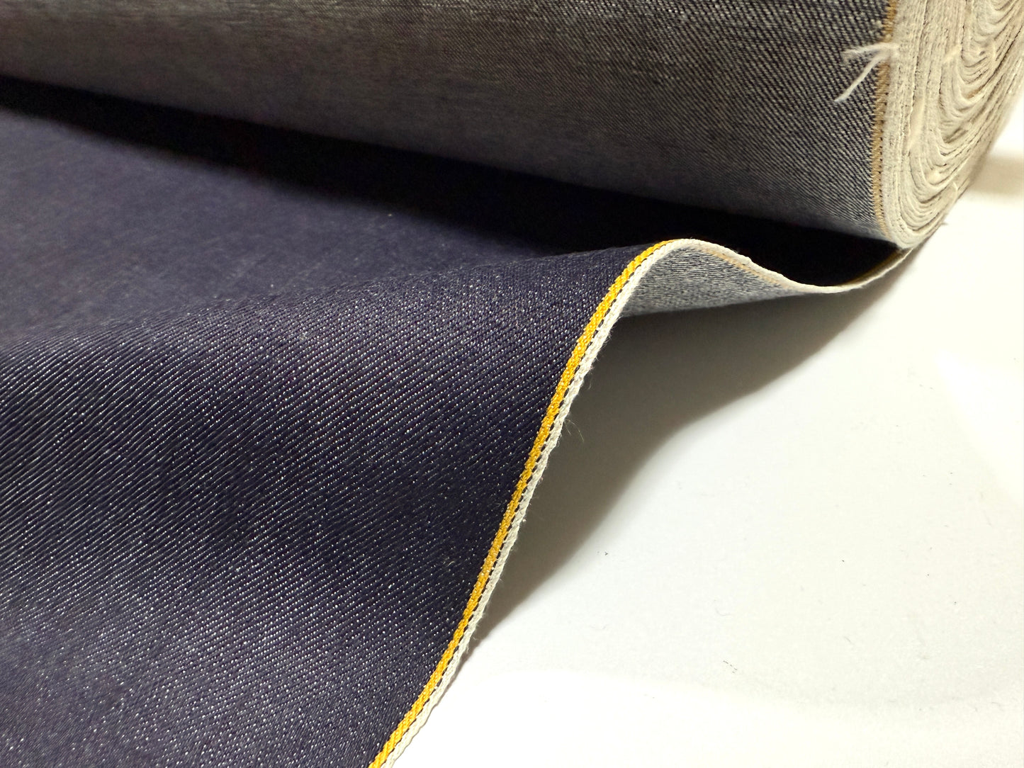 Okayama Denim | 13 oz indigo kibata Japanese selvage denim fabric yard with yellow selvage edge.
