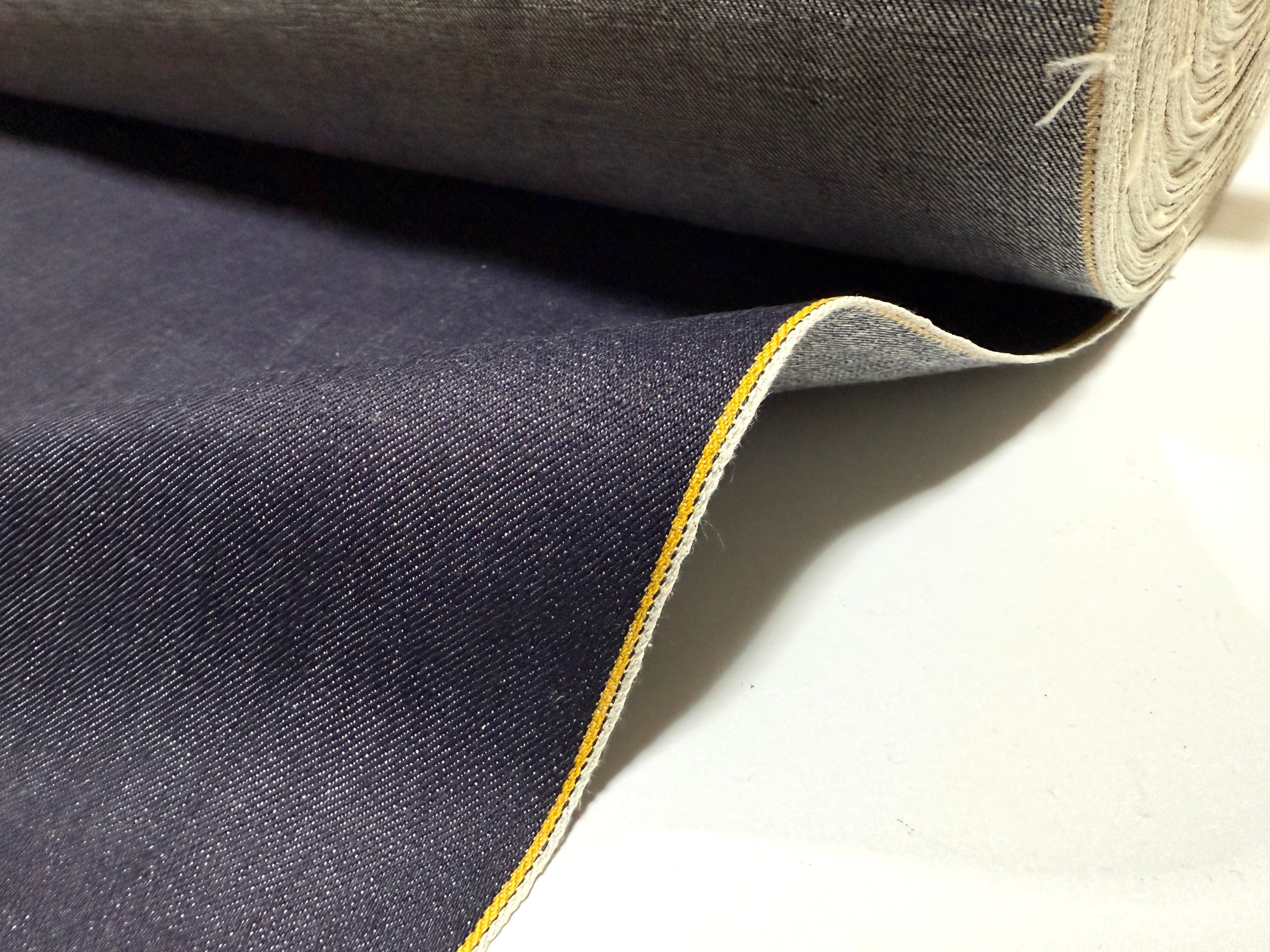 Okayama Denim | 13 oz indigo kibata Japanese selvage denim fabric yard with yellow selvage edge.