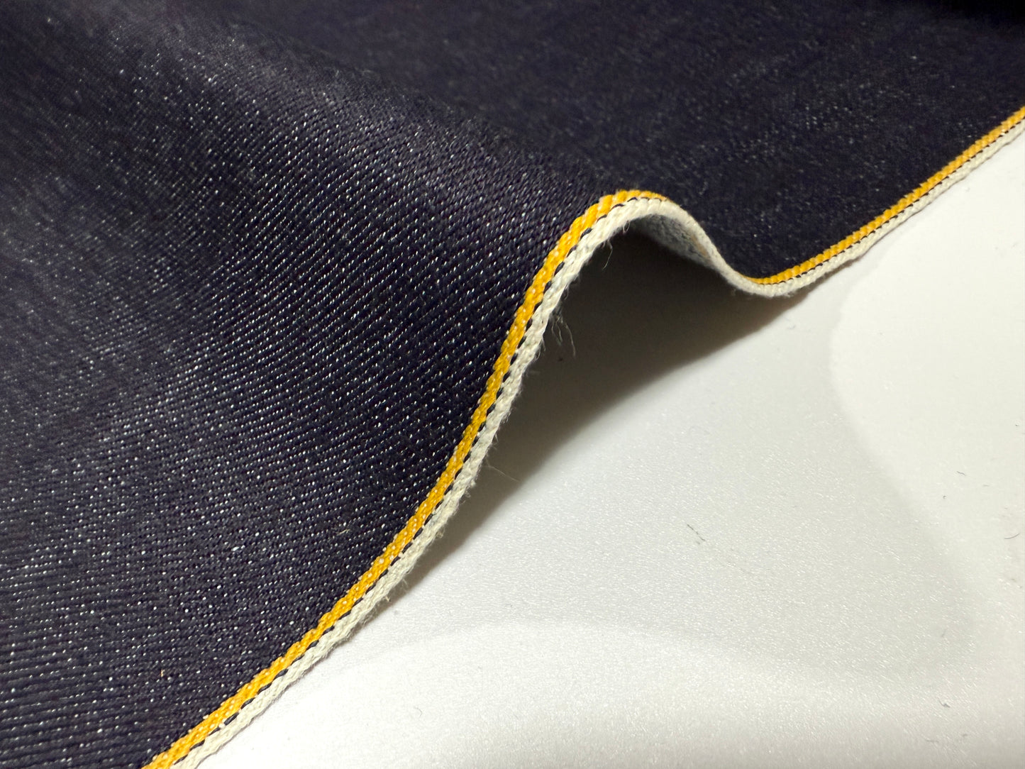 Okayama Denim 13 oz Indigo Kibata Japanese selvage denim fabric with yellow selvage detail, showcasing premium quality.
