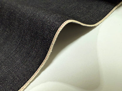 Okayama Denim | Close-up of 16.5 oz Japanese heavy ounce indigo selvage denim fabric edge.