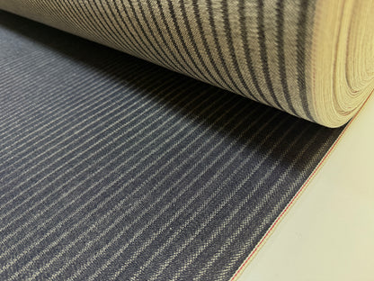 Okayama Denim roll showcasing 11.3 oz Black Selvedge Hickory fabric with distinctive workwear stripe pattern.