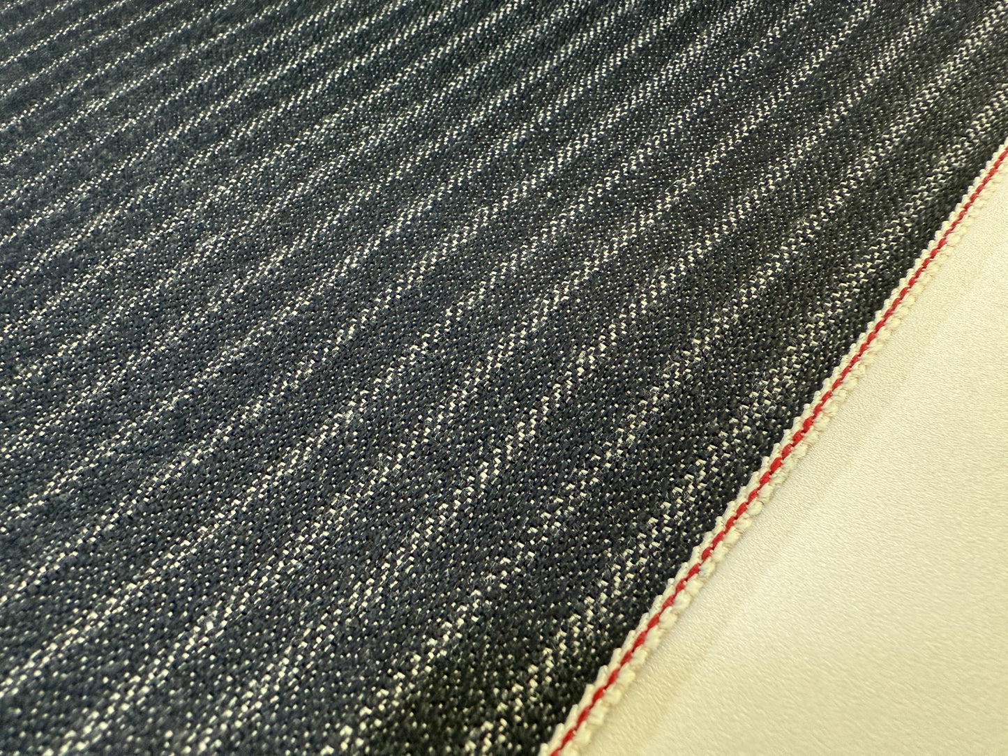 Okayama Denim | Close-up of 11.3 oz Black Selvedge Hickory Denim fabric showing the modern stripe pattern.