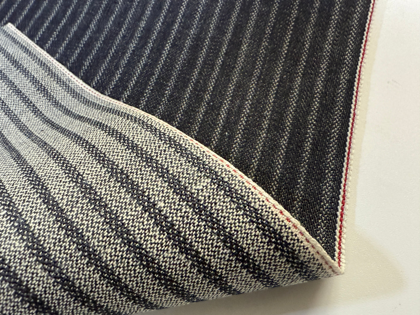 Okayama Denim 11.3 oz Black Selvedge Hickory with striped pattern and raw edge detail