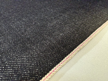 Okayama Denim 14.6oz Japanese Cotton Black Selvage Denim close-up showing its texture and selvedge detail.