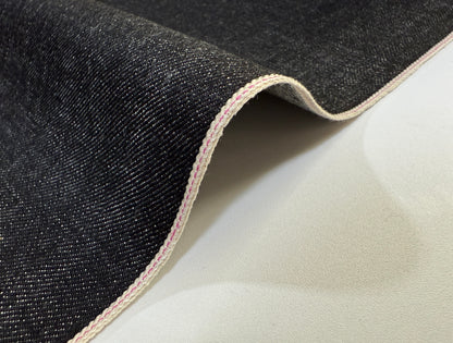 Okayama Denim 14.6oz Japanese Cotton Black Selvage Denim fabric showing smooth texture and edge stitching.