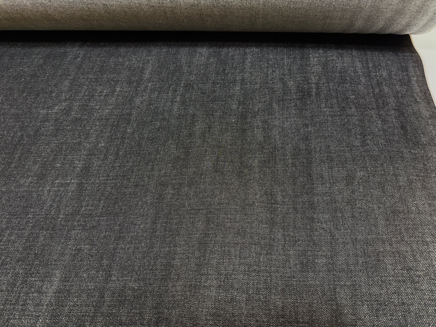 Okayama Denim - 14.6 oz Black Selvage Japanese Denim fabric roll showcasing smooth texture and durability.