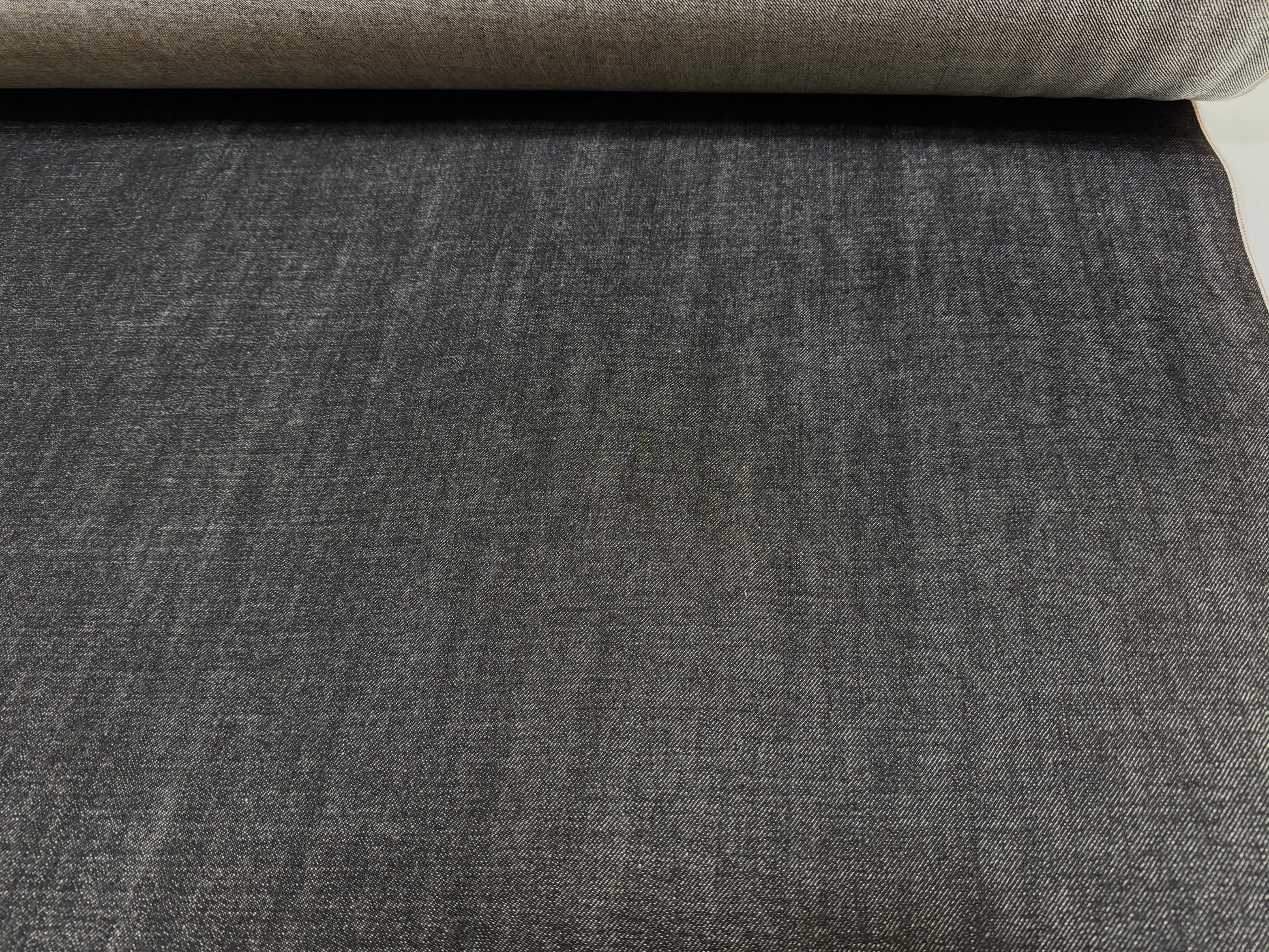 Okayama Denim - 14.6 oz Black Selvage Japanese Denim fabric roll showcasing smooth texture and durability.