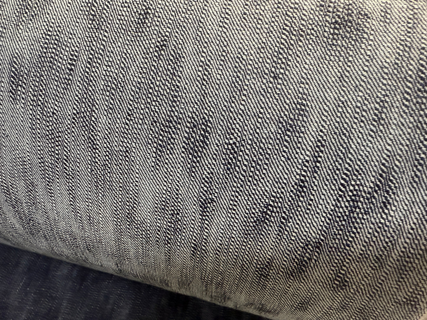 Close-up of Okayama Denim 16.5oz Japanese Indigo uneven dyed slab selvage denim texture.