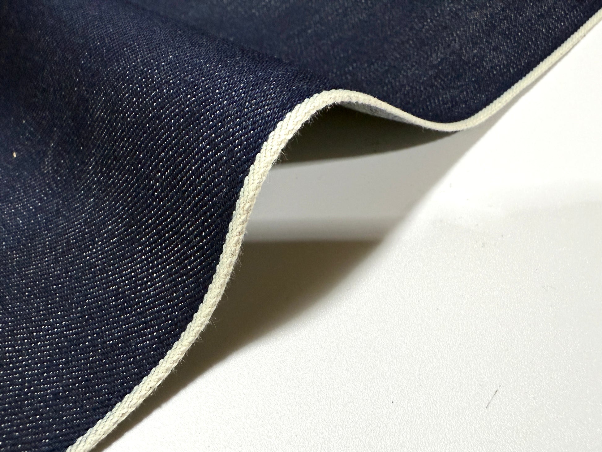 Okayama Denim | 15oz Indigo Selvage Japanese Blue fabric showcasing its smooth texture and selvage edge.