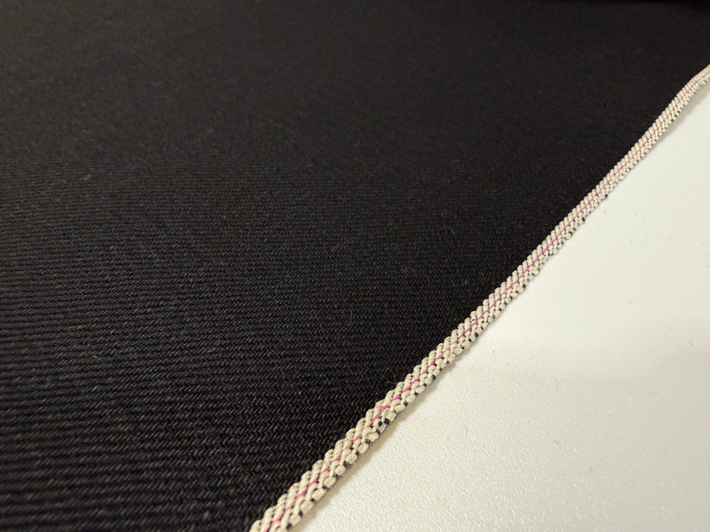 Okayama Denim | 14.6 oz double-sided black Japanese selvage fabric showcasing smooth texture and quality craftsmanship.