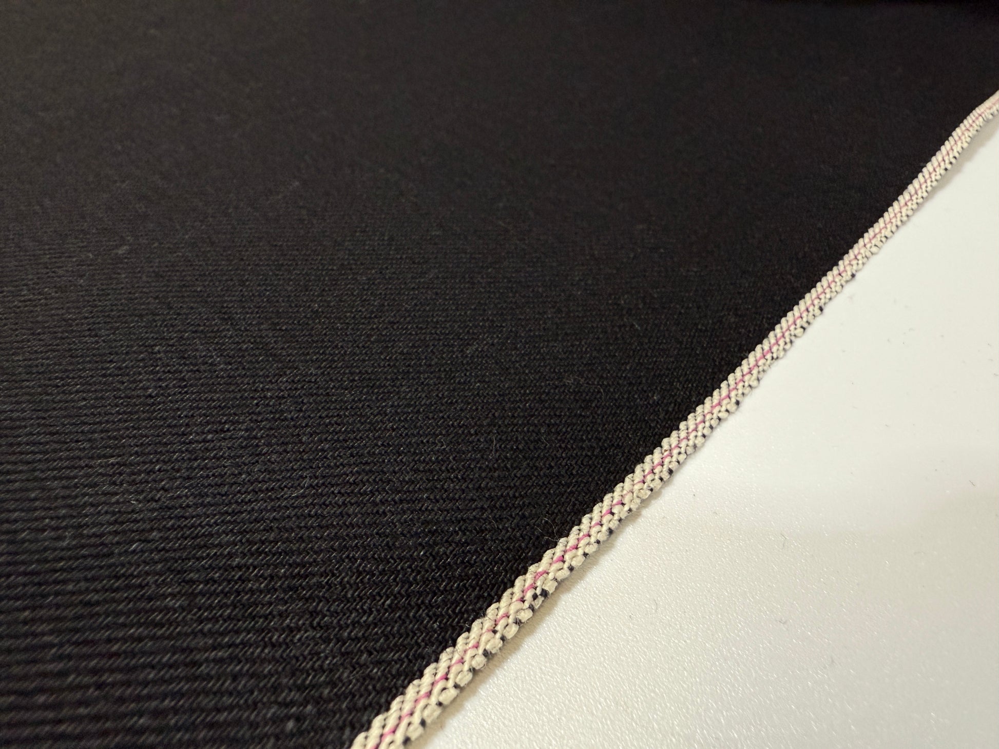 Okayama Denim | 14.6 oz double-sided black Japanese selvage fabric showcasing smooth texture and quality craftsmanship.