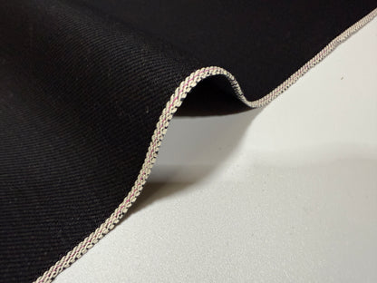 Okayama Denim | 14.6oz double-sided black Japanese selvage fabric with smooth texture and signature edge.