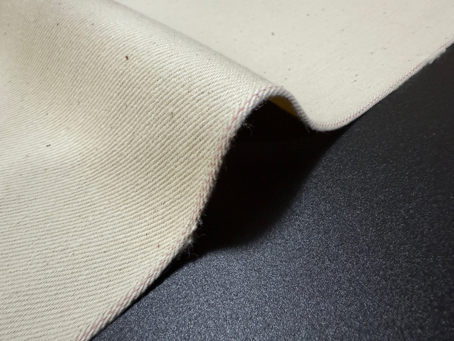 Okayama Denim fabric showing ecru selvage texture and craftsmanship from Japan, perfect for apparel making.