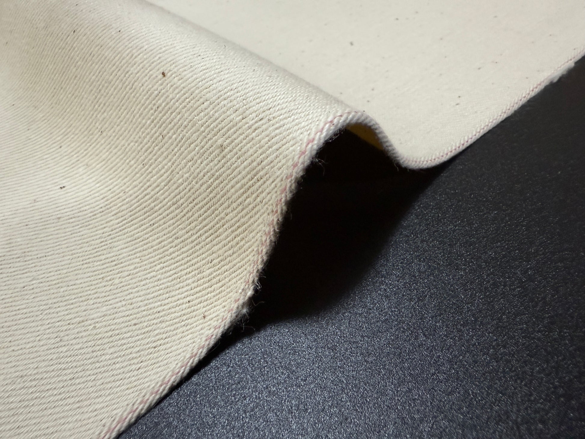 Okayama Denim fabric showing ecru selvage texture and craftsmanship from Japan, perfect for apparel making.