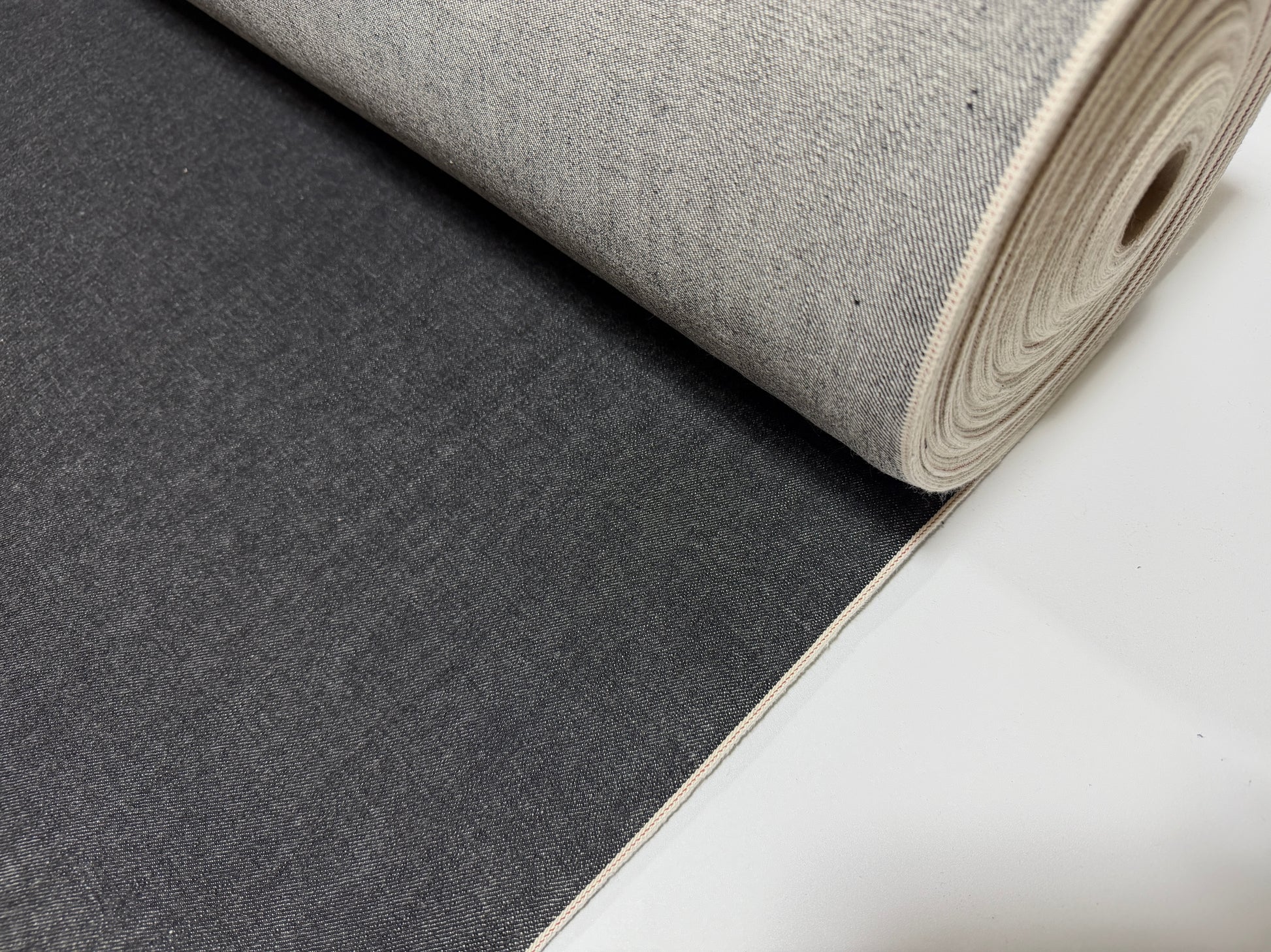 Okayama Denim 14.5oz black selvage Japanese cotton denim roll showcasing smooth texture and durability.