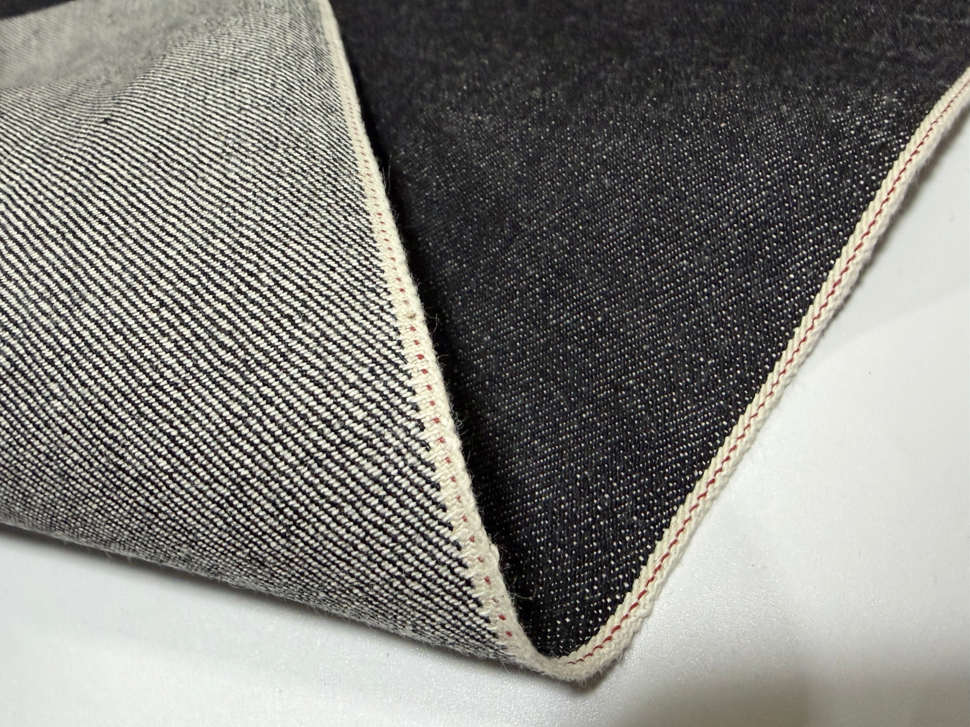 Okayama Denim 14.5 oz Japanese cotton black selvage denim fabric showcasing its smooth texture and quality craftsmanship.
