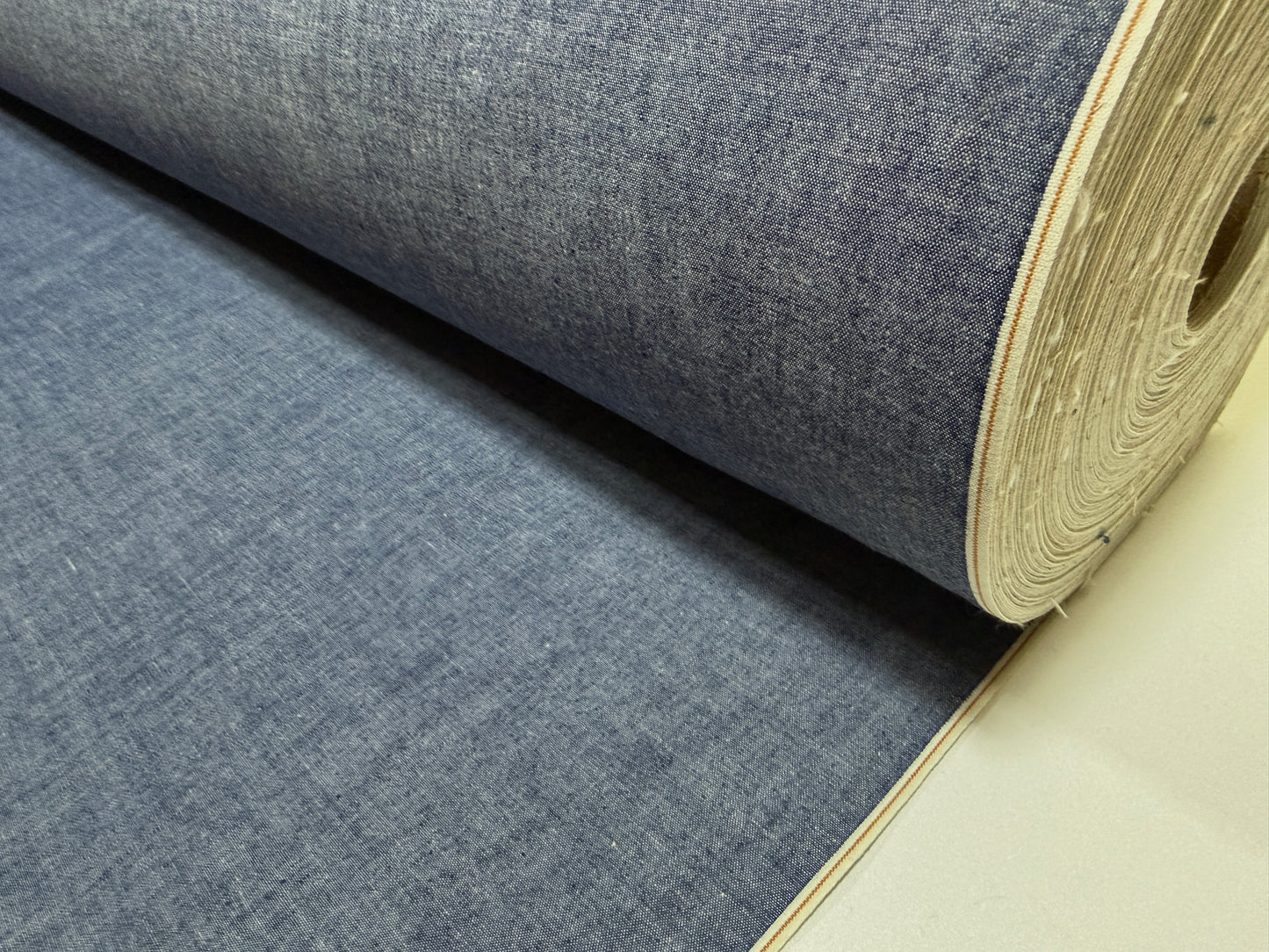 Okayama Denim 4.5 oz Japanese indigo selvage chambray fabric roll showing rich texture and color.