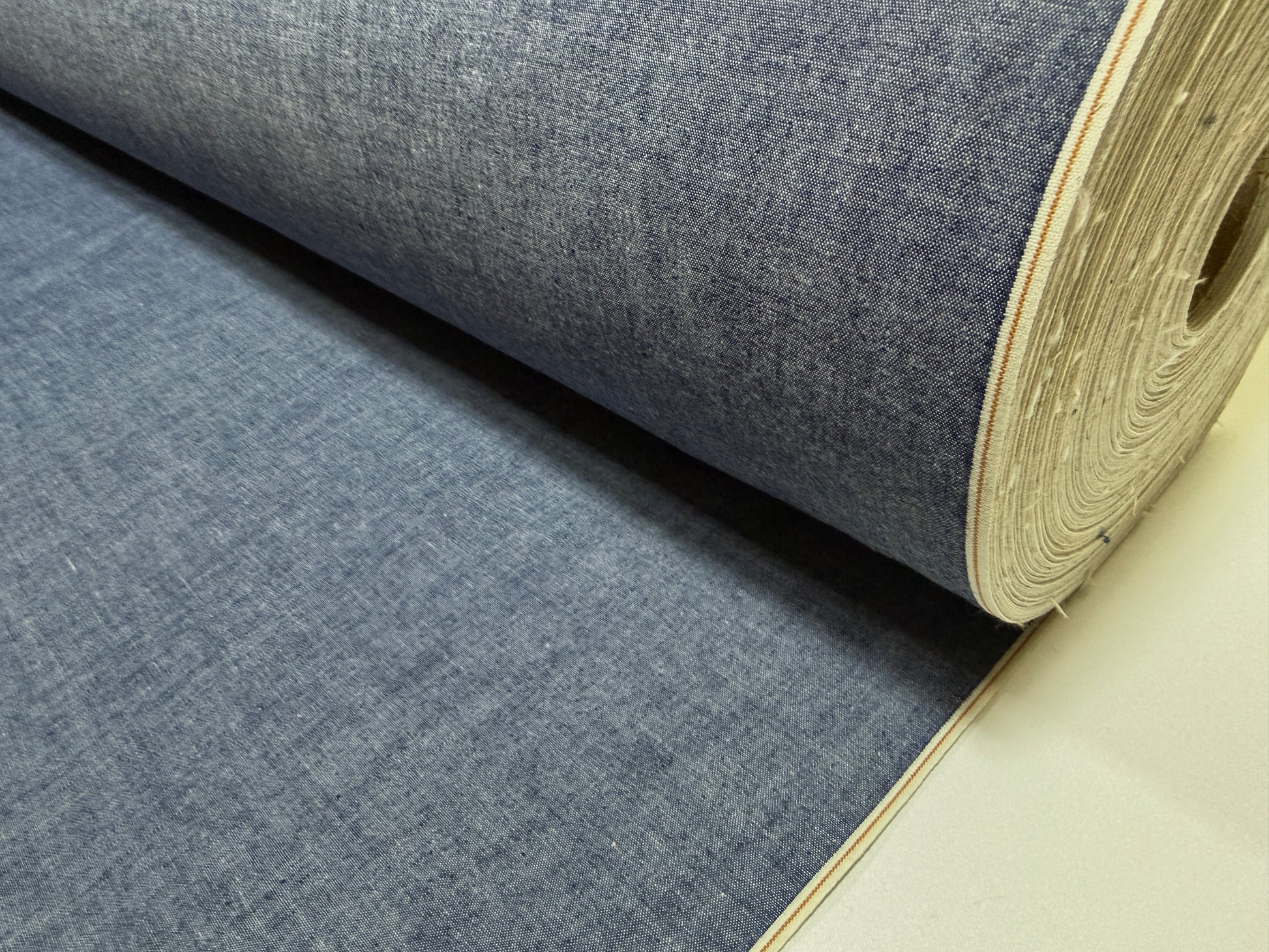Okayama Denim 4.5 oz Japanese indigo selvage chambray fabric roll showing rich texture and color.