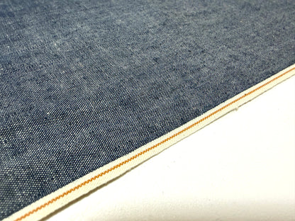 Okayama Denim 4.5 oz Japanese indigo selvage chambray fabric close-up with a crisp edge.